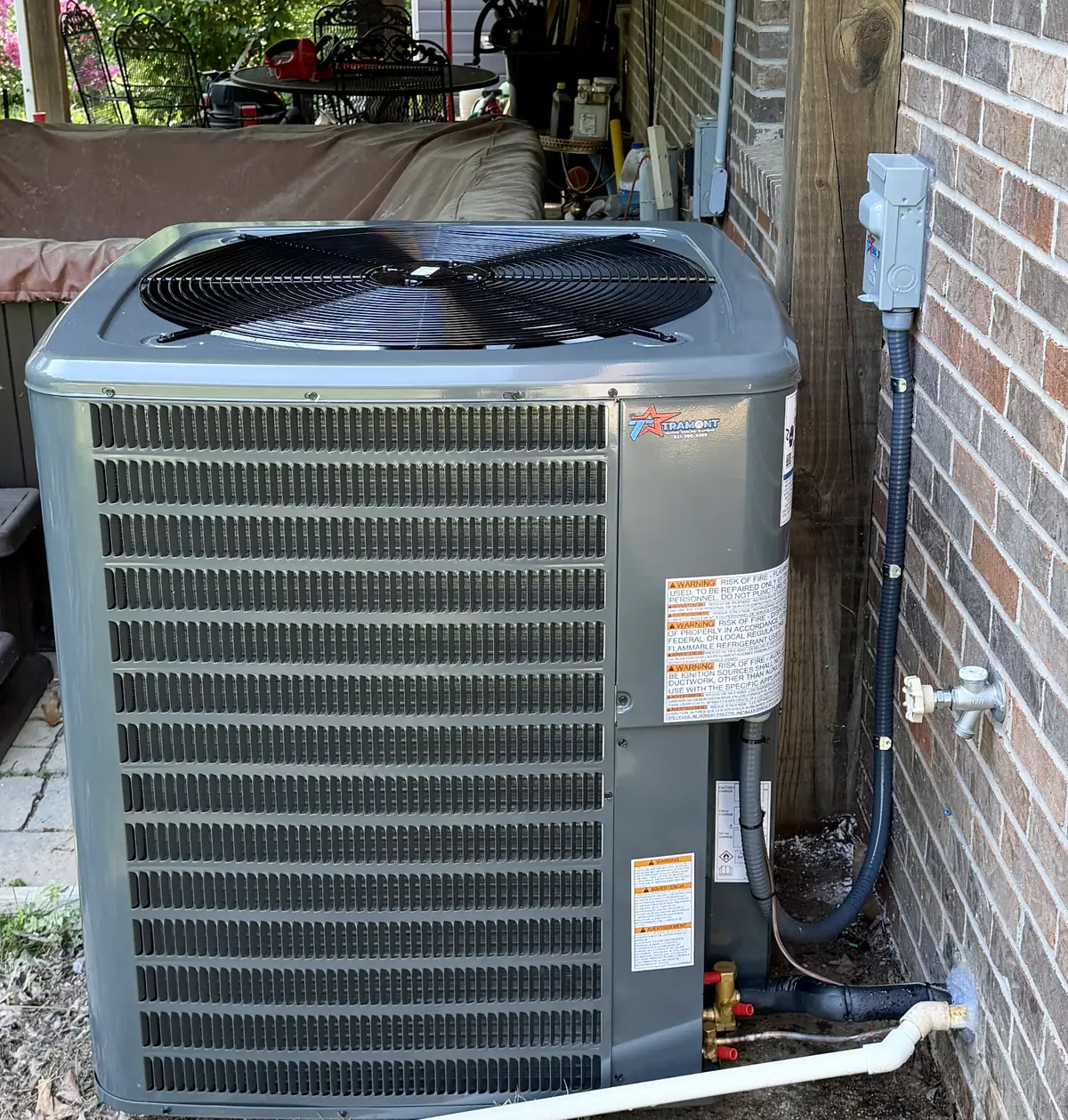 Air conditioner with Tramont Heating Cooling Plumbing logo
