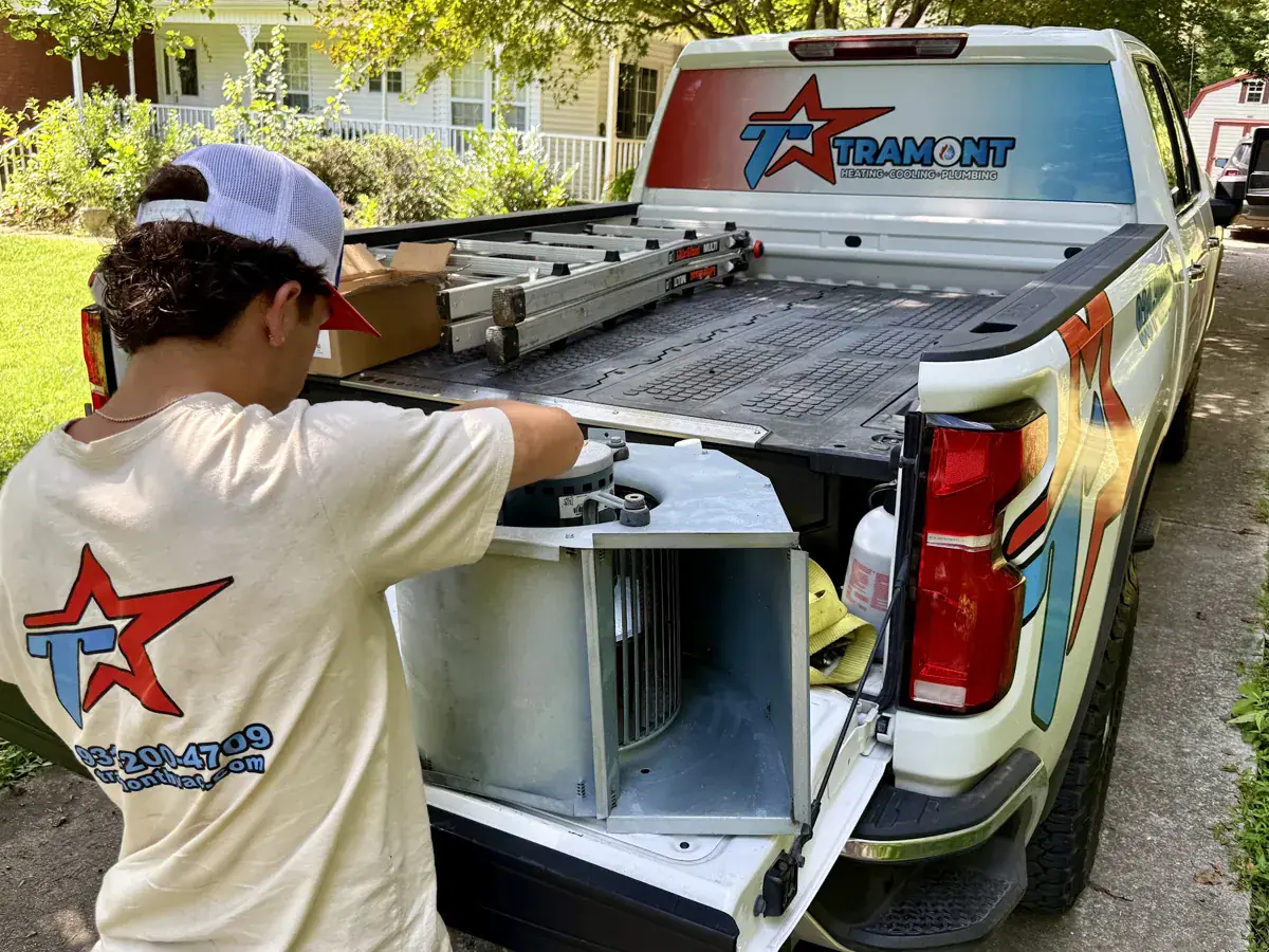 Tramont technician unloading equipment from a branded truck