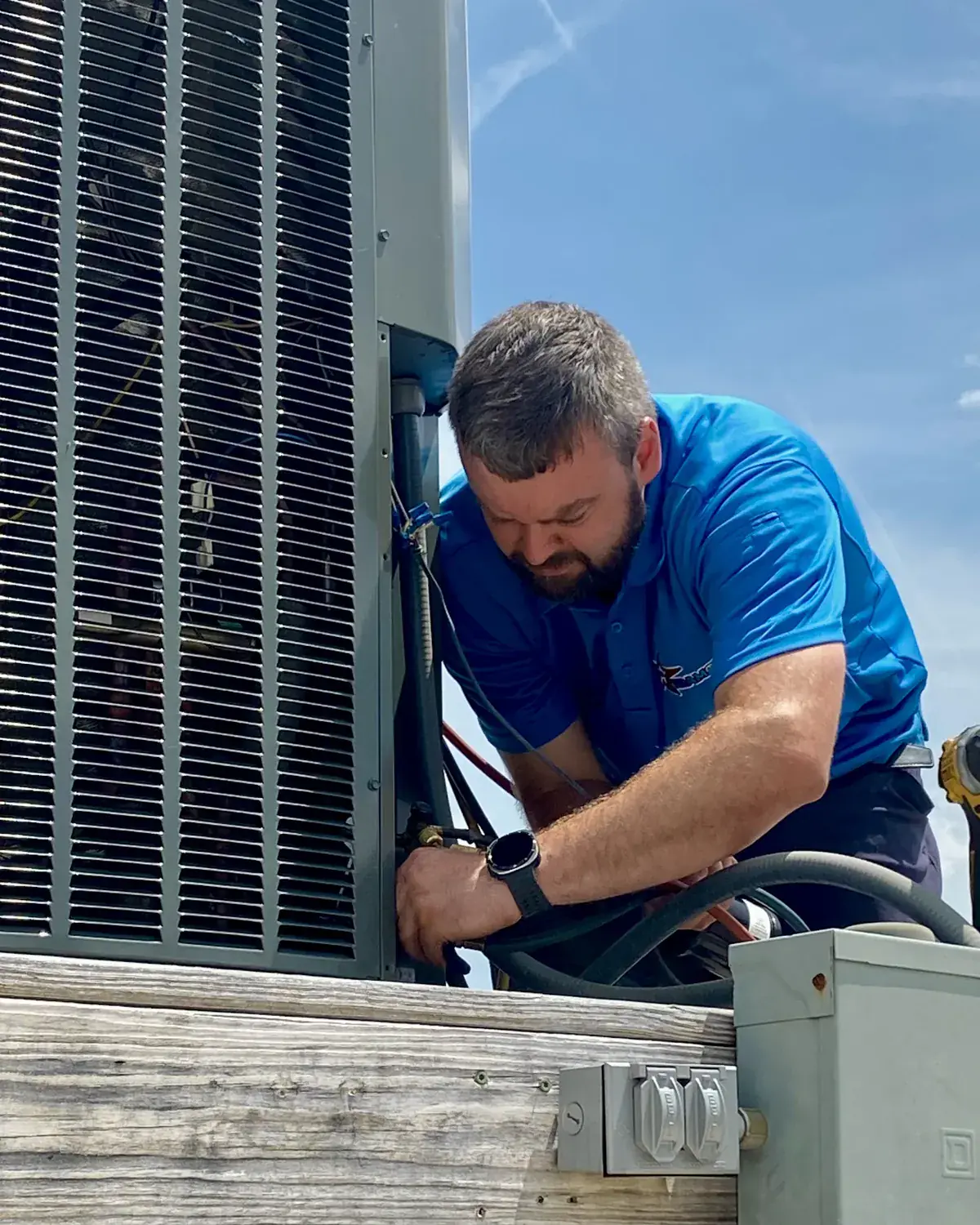 Tramont technician wiring an outdoor AC unit