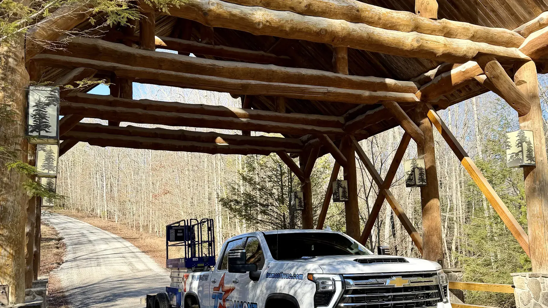 Tramont truck parked under a log pavilion