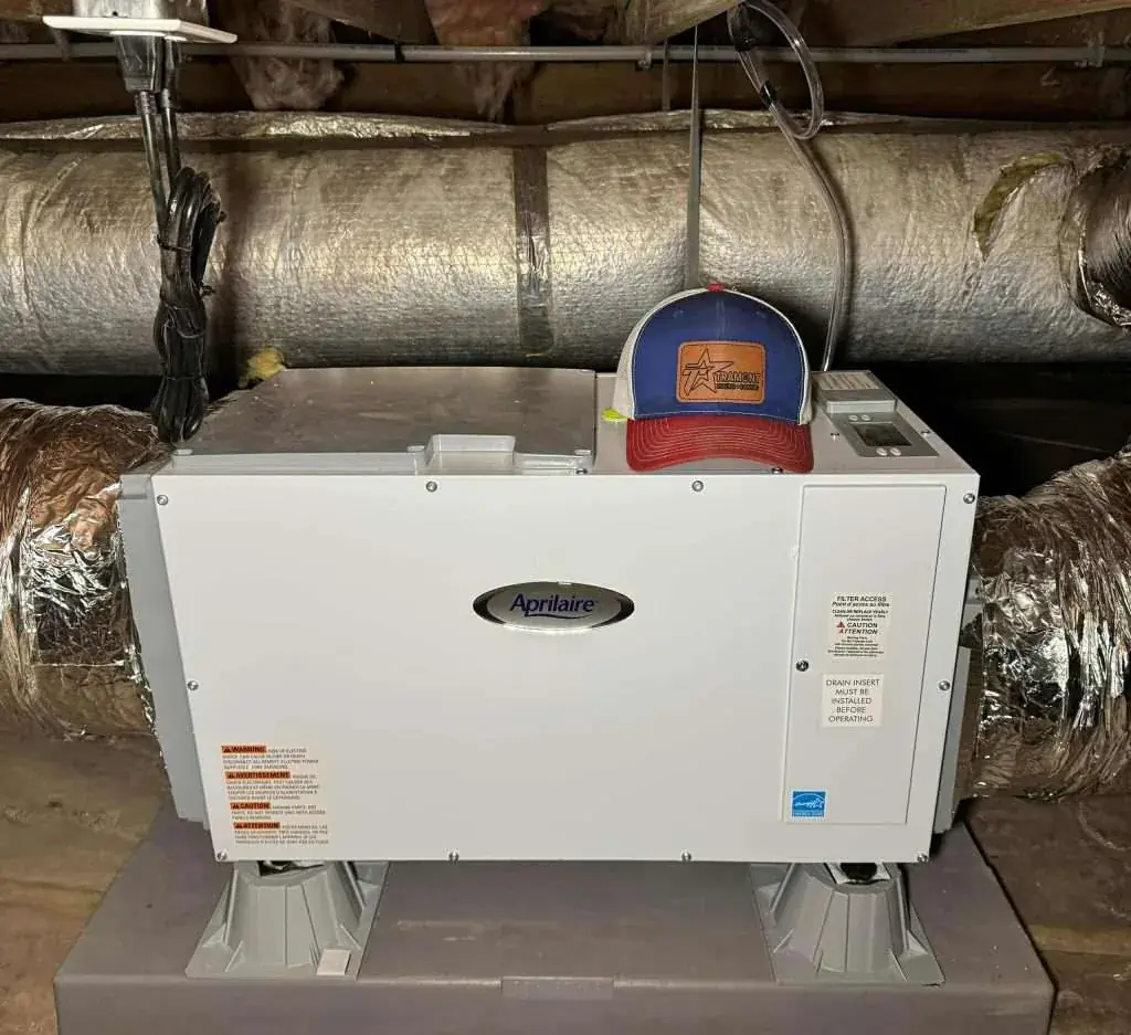 Whole-home dehumidifier installed in an attic